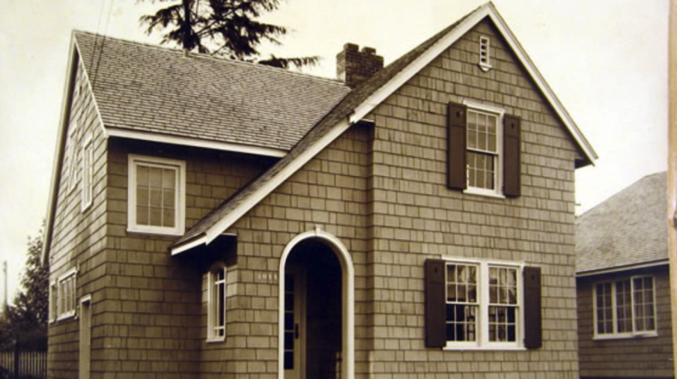 A sepia-toned photograph of a newly-built single-family house.